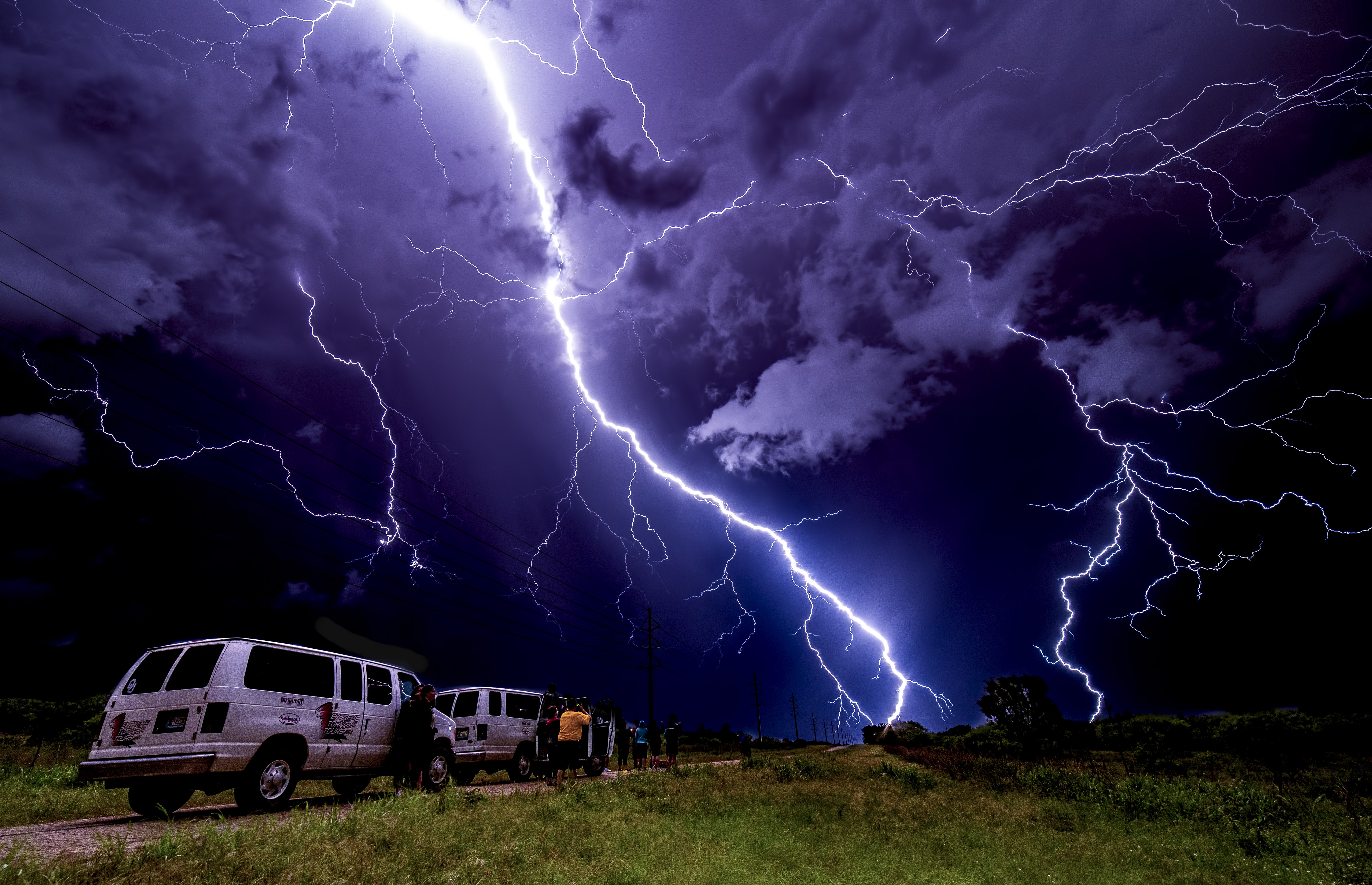 Lightning illuminates tour vans